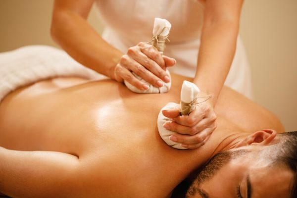 closeup-man-getting-back-massage-with-detox-herbal-balls-health-spa-1 closeup-man-getting-back-massage-with-detox-herbal-balls-health-spa-1